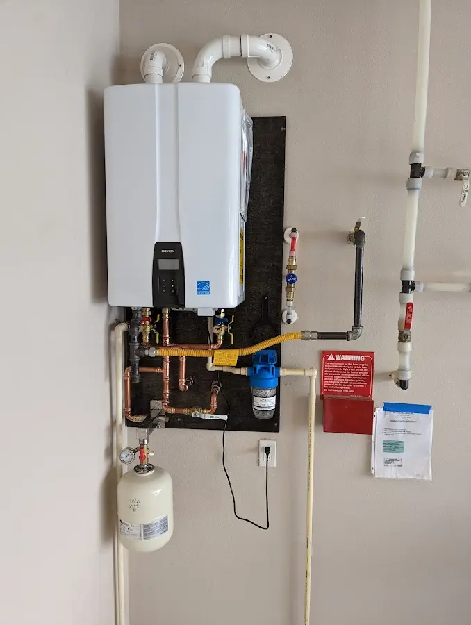 Professional plumber installing copper piping in a Penn Yan home